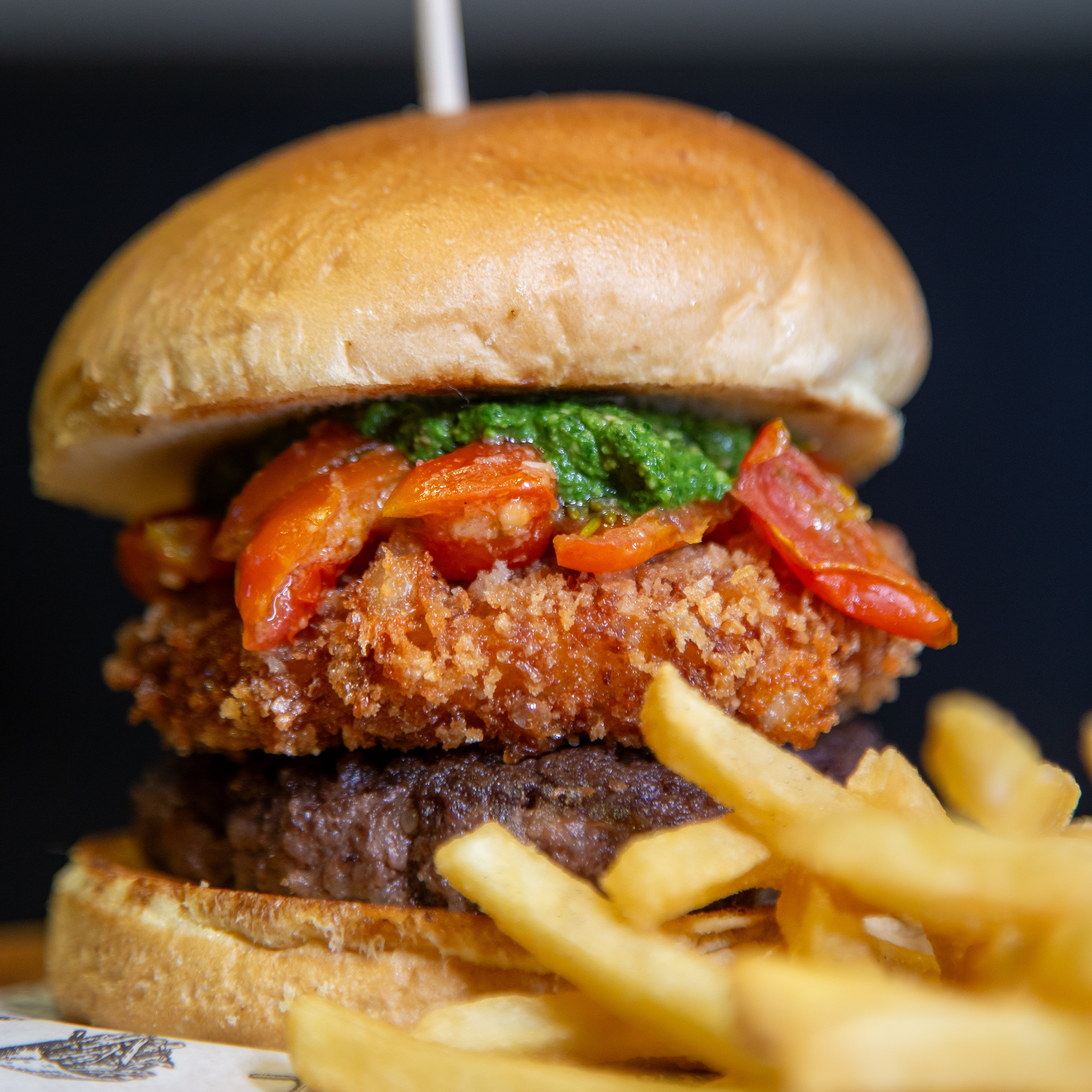 Hambúrguer de frango crocante com tomatinhos e fritas